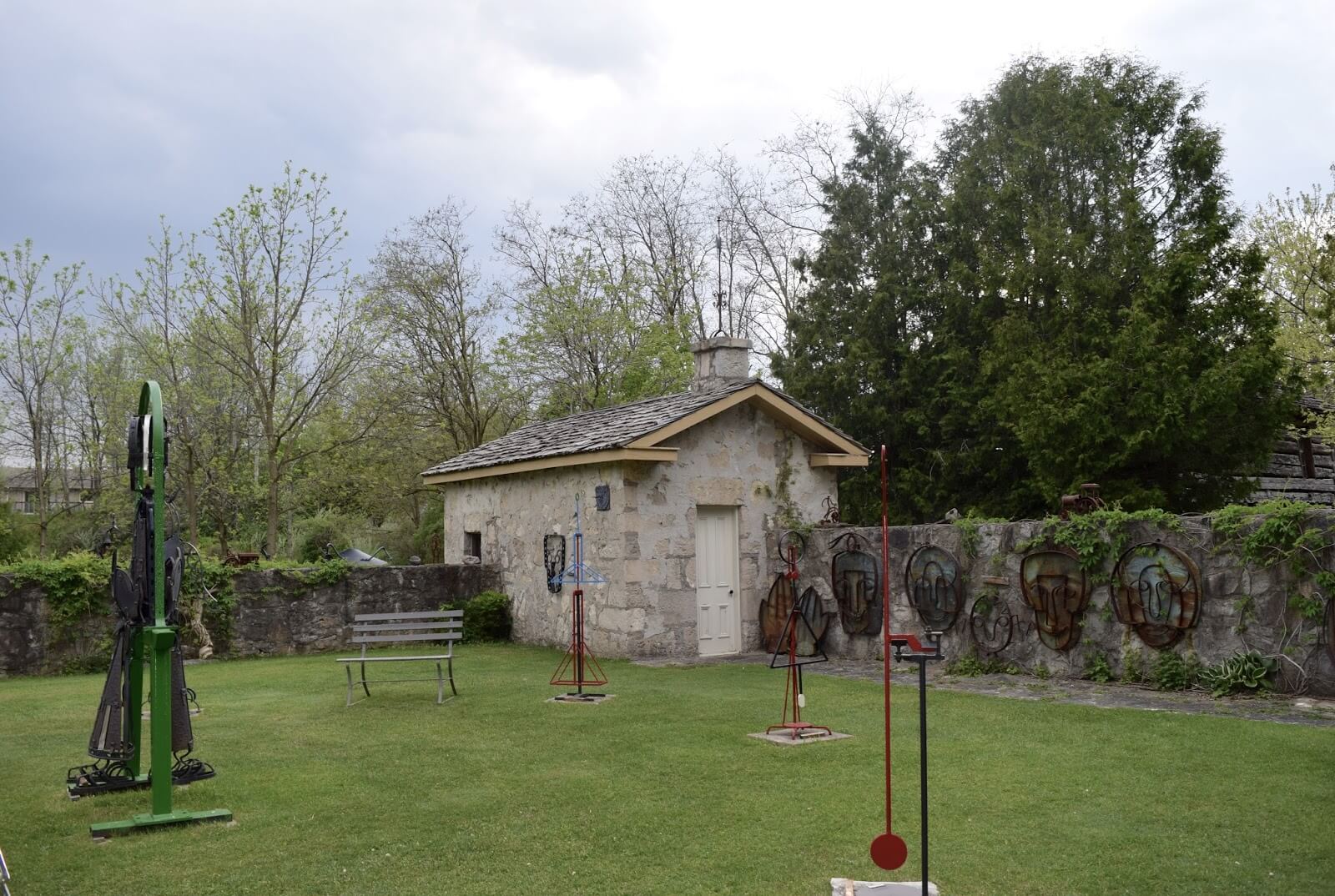 A small chapel building in the corner of the Academy courtyard attached to a wall and surrounded by sculptures.