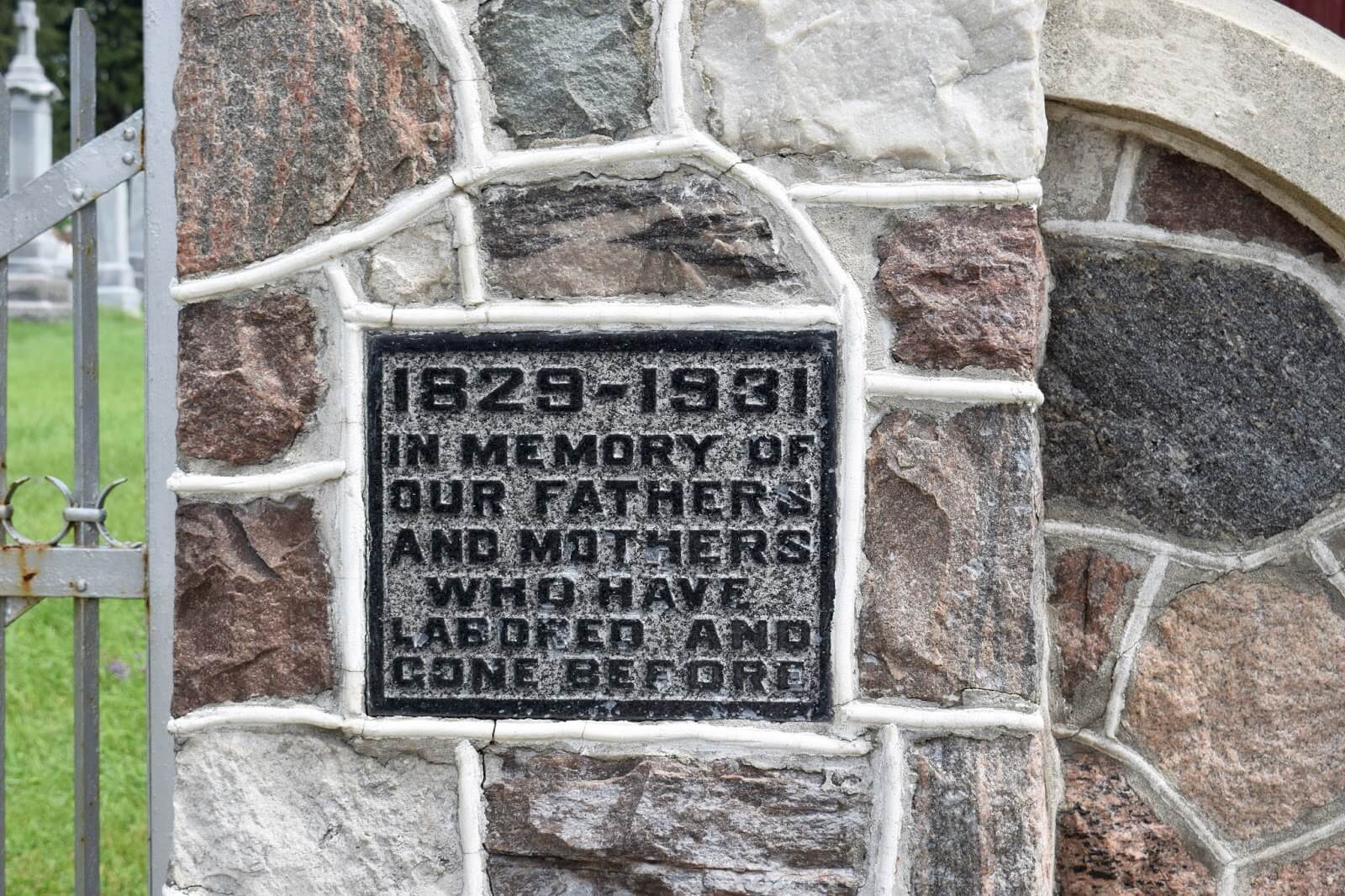 A plaque stating 1829-1931, In memory of our fathers and mothers who have labored and gone before.