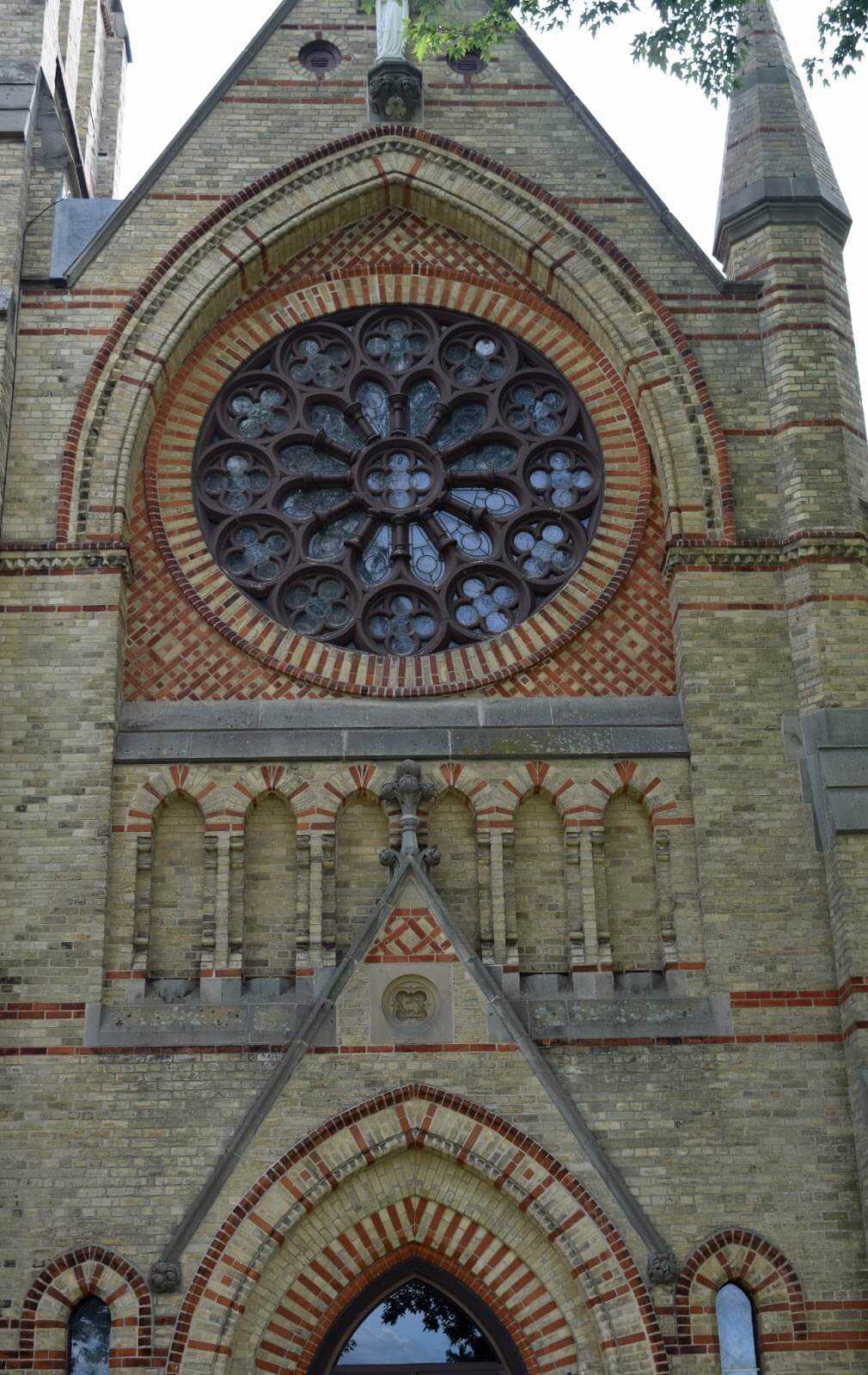 The outside of a stain glass that's above the church entrance.