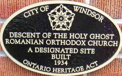 A plaque stating City of Windsor, Descent of the Holy Ghost Romanian Orthodox Church, A Designated Site Built 1934, Ontario Heritage Act.