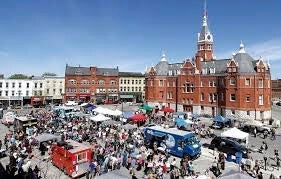 Stratforf City hall building and the market square busy with people and vendors