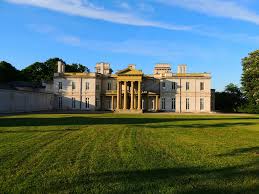 The front of a castle named Dundurn Castle from Hamilton with a large green lawn in front