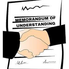 An illustration of a handshake with a memorandum of understanding in the background
