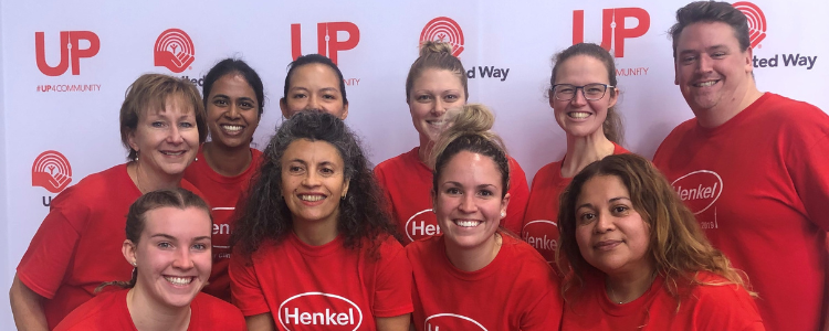 Group of Henkel employees and co-op students posing for a photo in their Henkel t-shirts