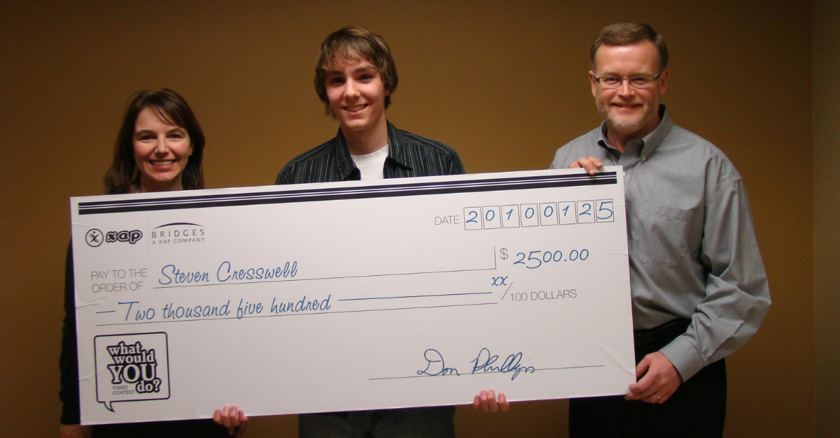 UWaterloo Math alum, Don Phillips holding a cheque with the co-op student recipient, Steven Cresswell