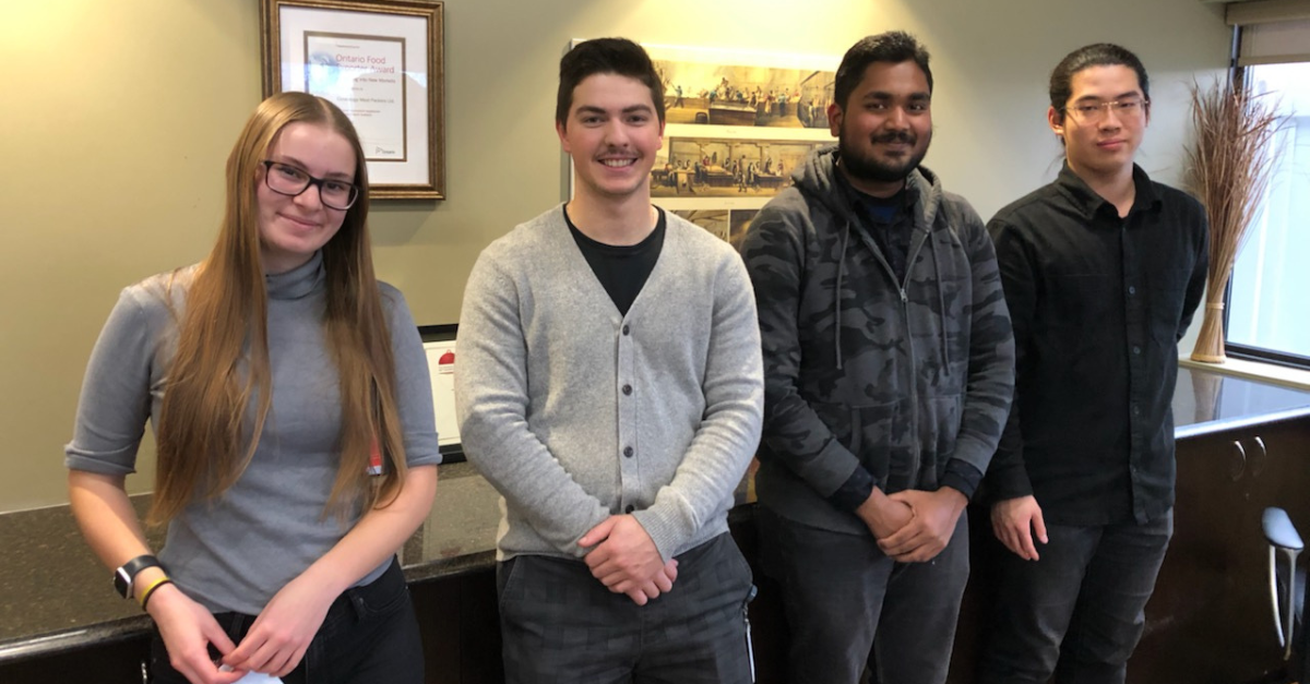 Four co-op students working at Conestoga Meats