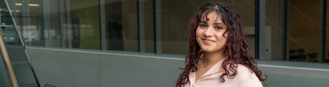 Co-op student with long curly hair smiling