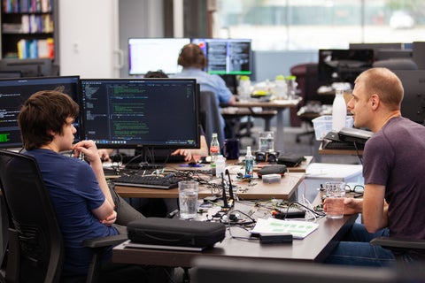 Waterloo co-op student and Adhawk employee working with code on a monitor