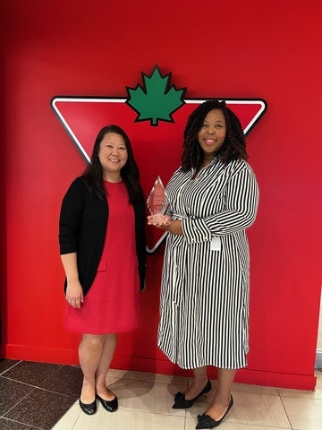 Julie Hartley and Letecia Rose holding the 2023 Employer Impact Award plaque