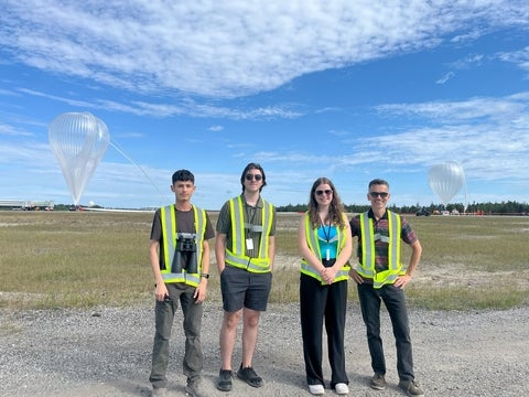 co-op students standing in front of hot air balloon launch 