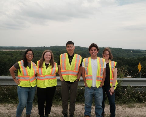 Group of Region of Waterloo employees and co-op students posing for a group photo at a waste management site