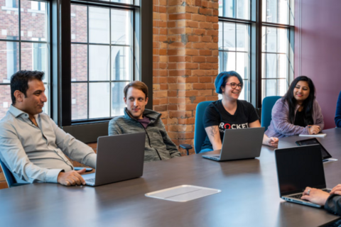 Group of Rocket Innovation employees and co-op students during a meeting