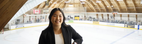girl standing in front of an arena