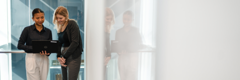 Female employer and co-op student looking at a laptop