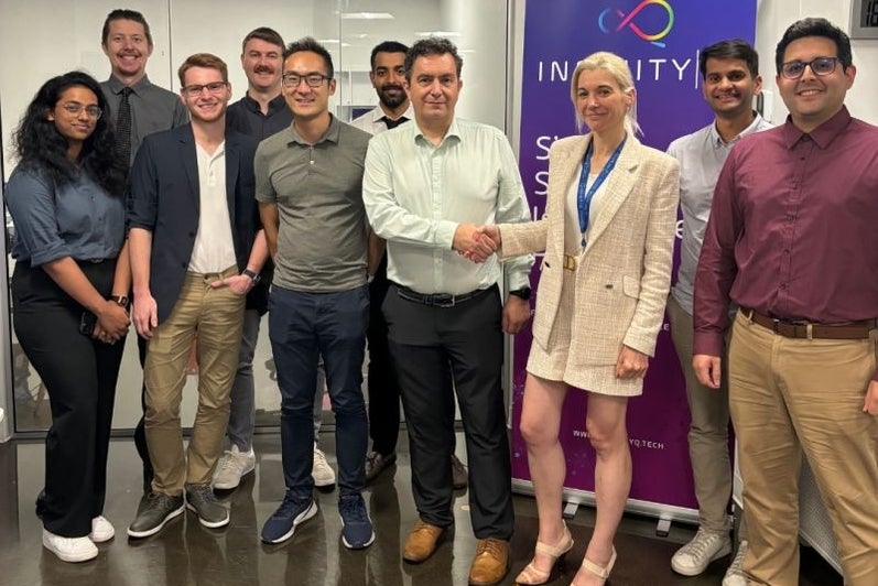 A group of team members pose staring at the camera in an office