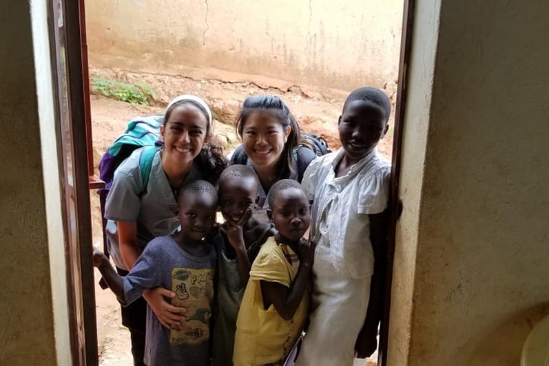 FullSoul co-op students smiling with children from Uganda