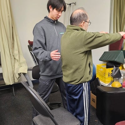 Christopher Wong, Physiotherapist at First Markham guiding an elderly patient to exercise