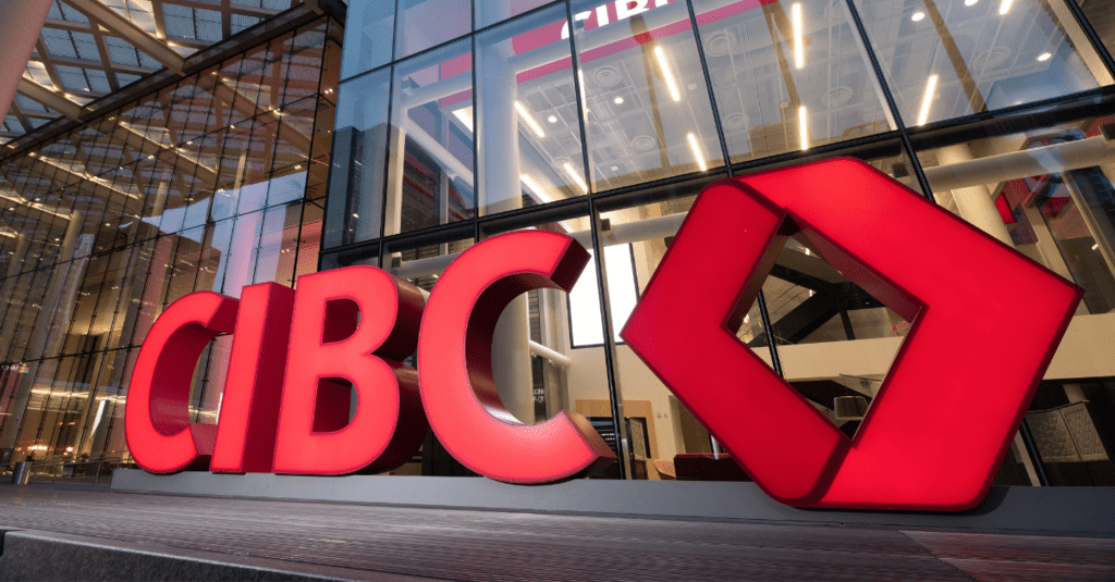 CIBC logo in large red letters outside a modern glass building.