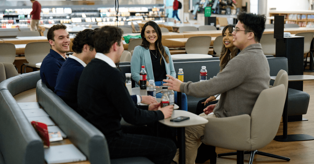 Deloitte co-op students sitting around a table at a team lunch