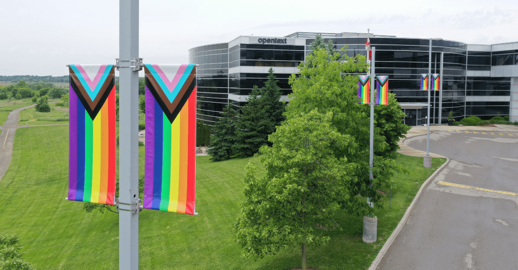 View of exterior of OpenText office building with LGBTQ+ pride flags