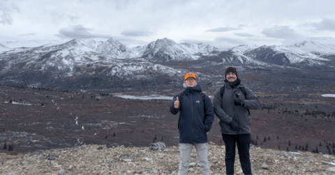 Two male Waterloo co-op students pose in front of the mountains in Whitehorse