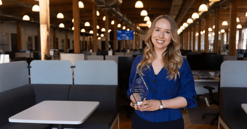 Meghan Lacoste from Compass holding trophy