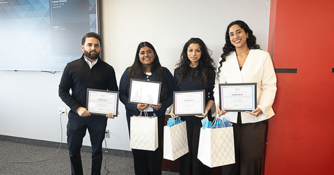 Four students holding awards