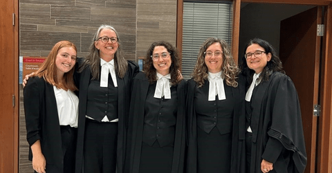 Lawyers posing for image in law regalia 