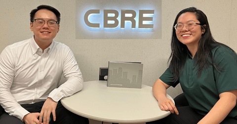 Co-op students sitting at a desk in a CBRE Investment Management office