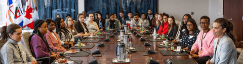 co-op students sitting at a government board room table