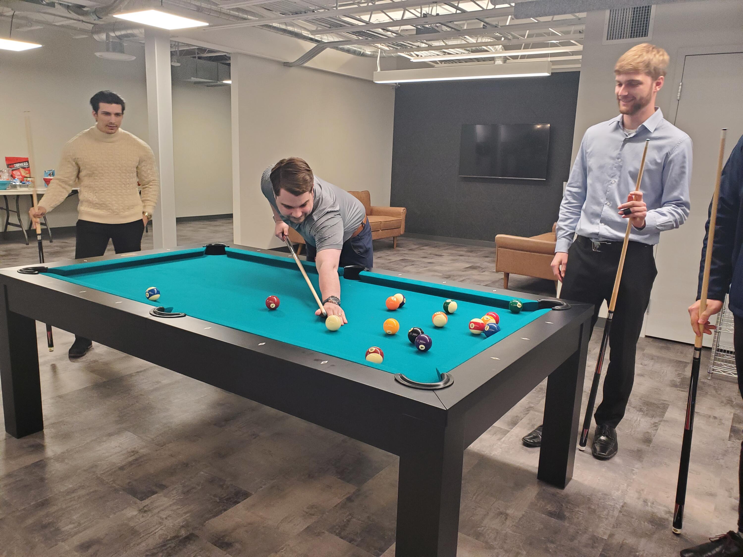 MAC LLP co-op students playing pool at the office