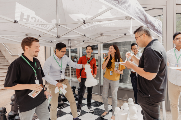 Group of Questrade co-op students and employees playing a life size version of Chess