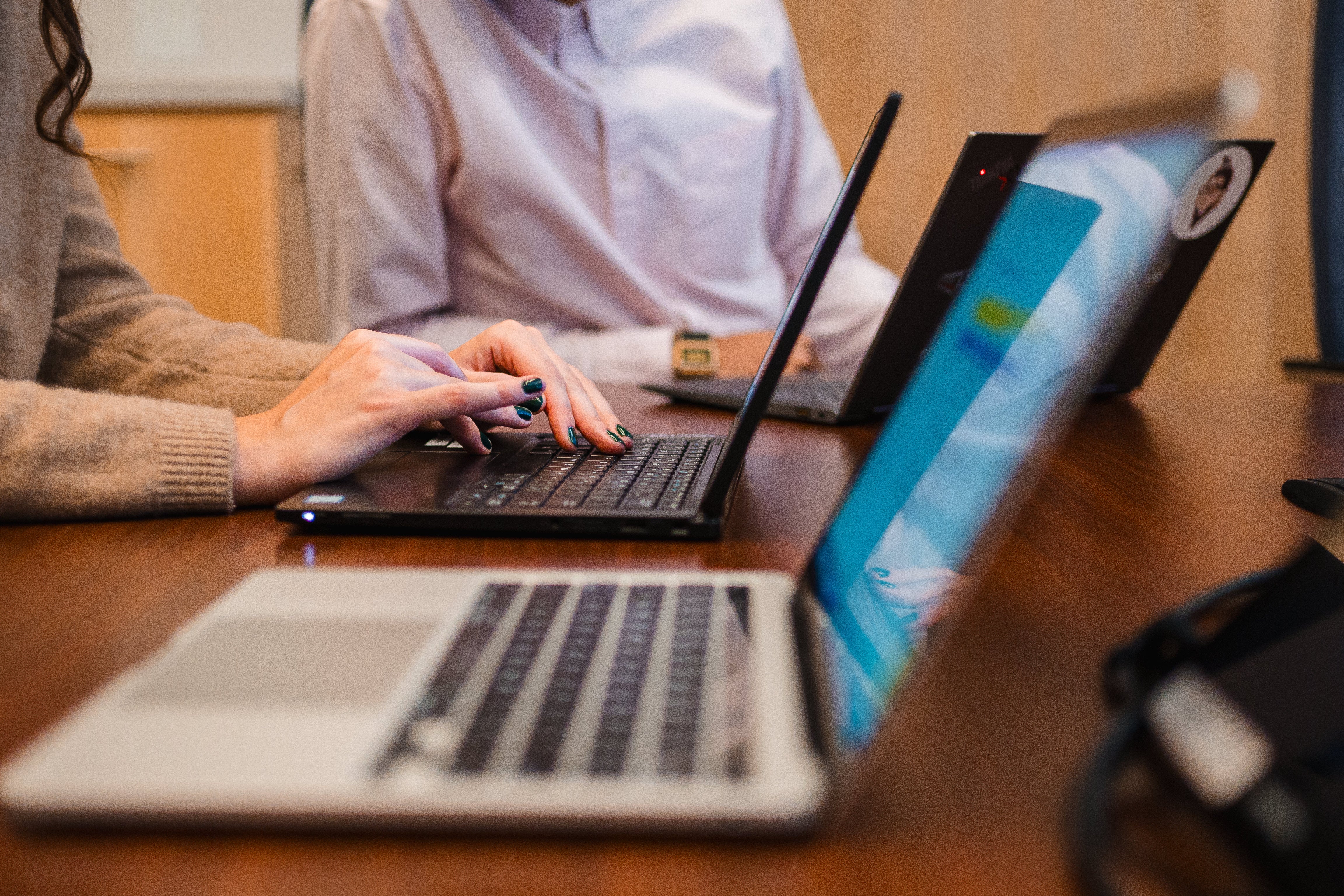 hands typing on laptop