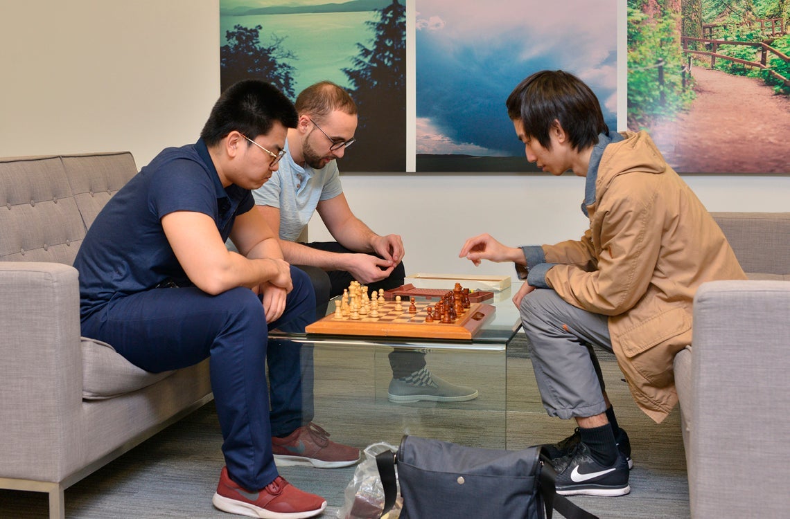 Co-op students and staff at Kenna playing chess at the office