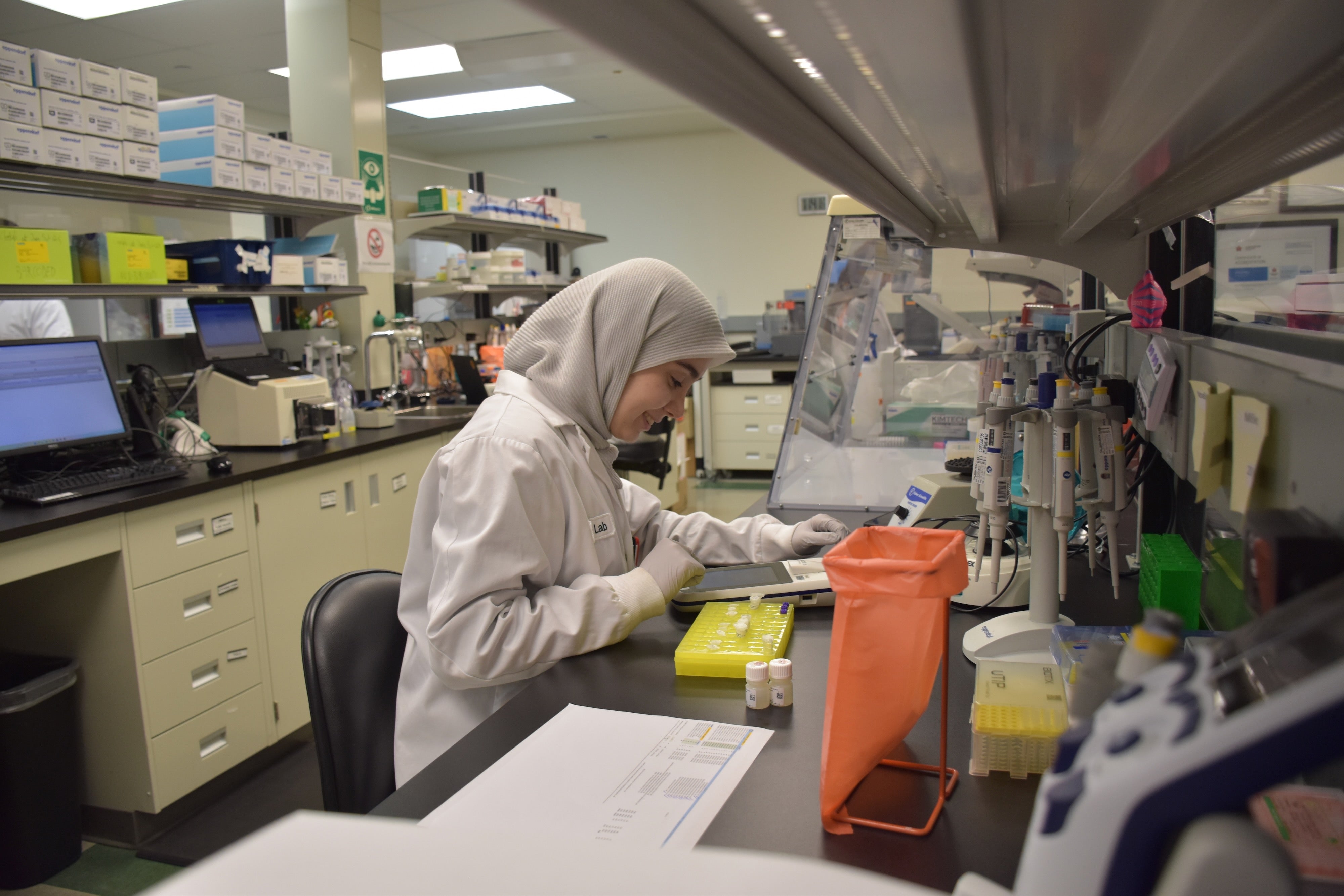 Female working on sampling at OICR lab