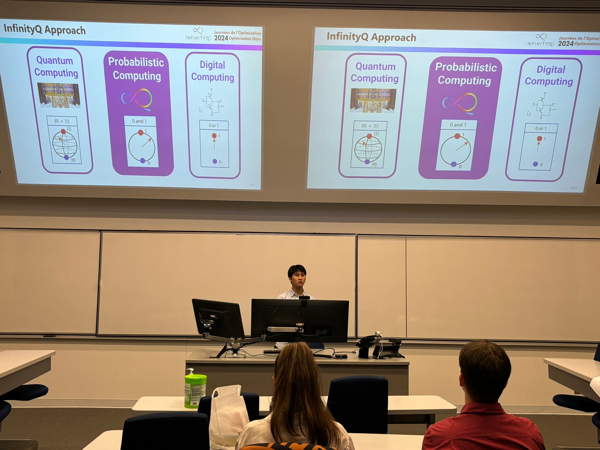 A student sits at a desk presenting a powerpoint presentation