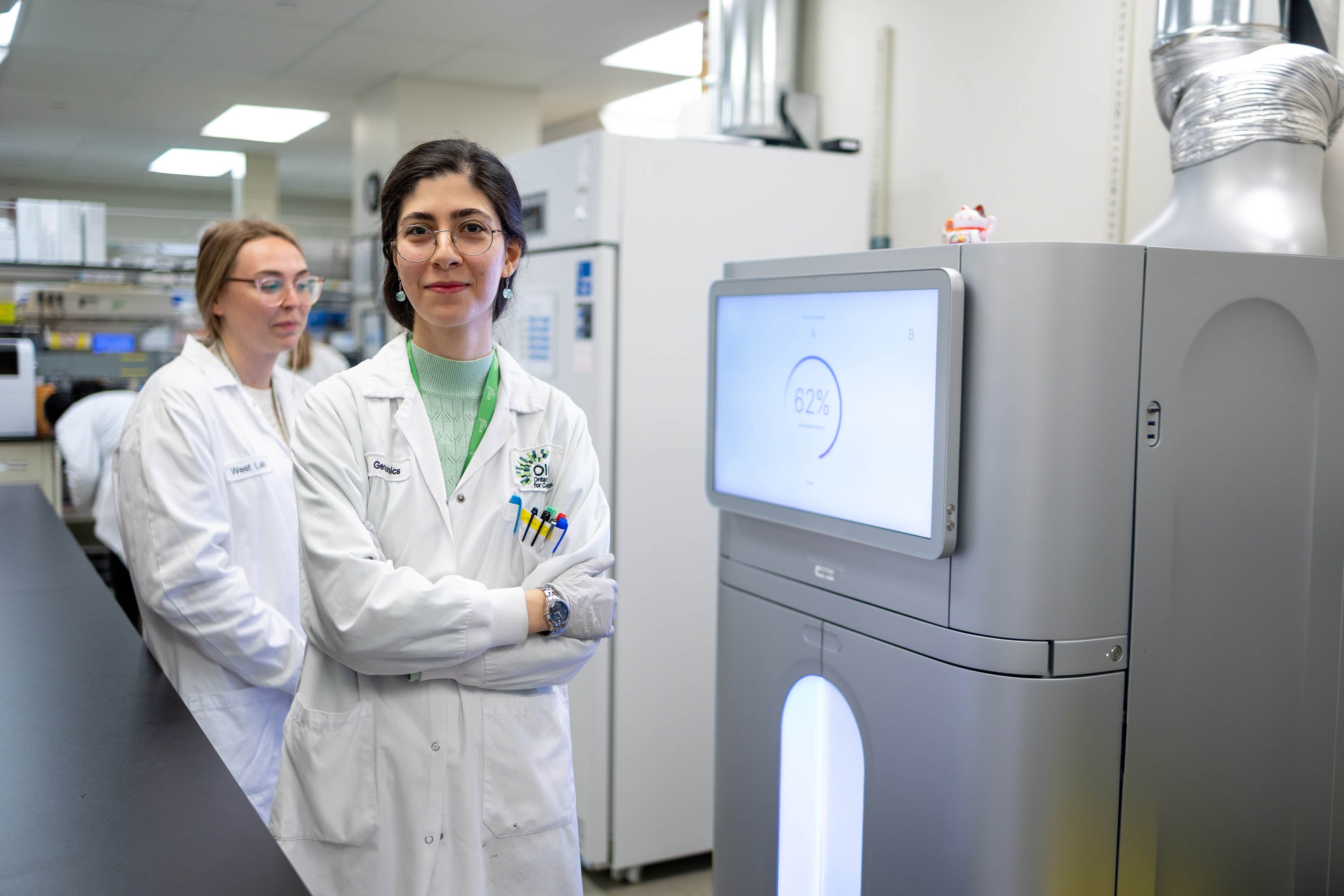 Female team members pose facing the camera in OICR's lab.