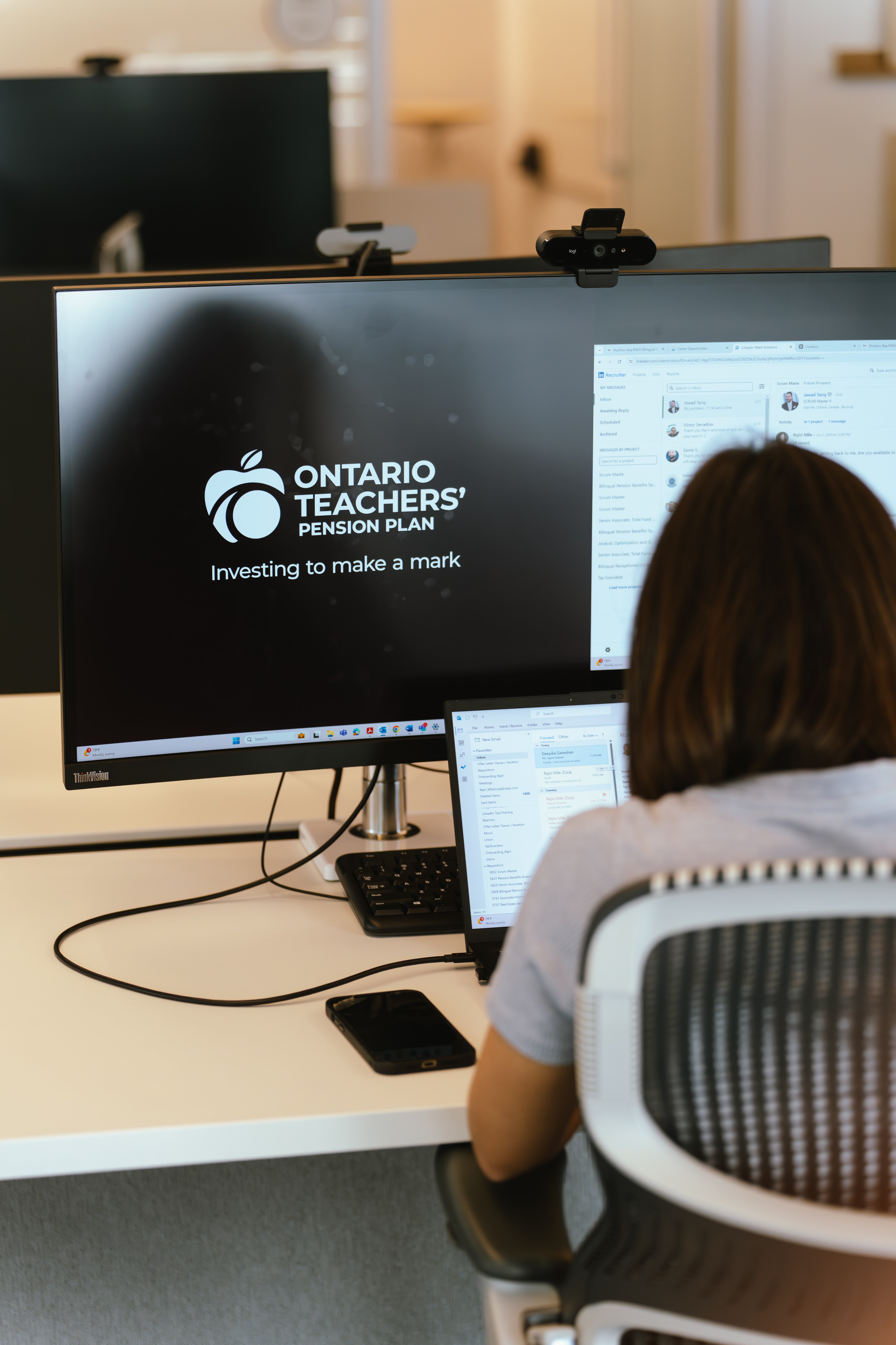 Female employee working on monitor displaying the OTPP logo