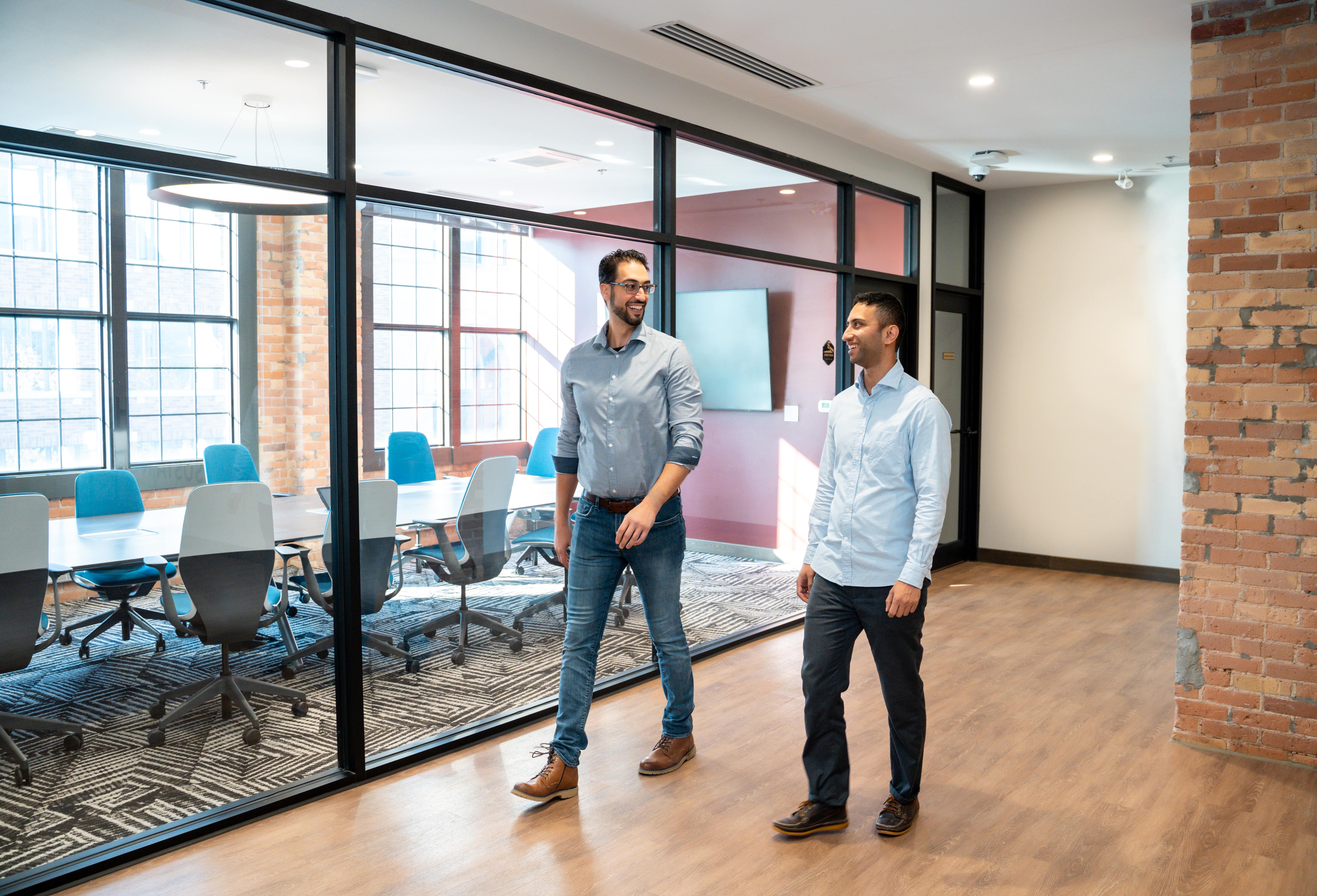 Two Rocket Innovation employees walking through the hallway at the office