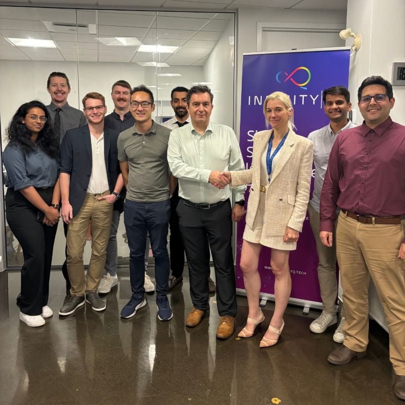 A group of team members pose staring at the camera in an office