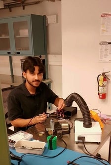 A student works on a device in the lab