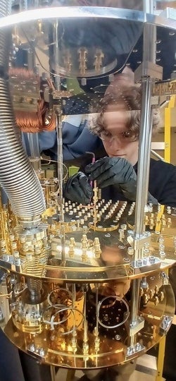 A student examines a device in the laboratory 
