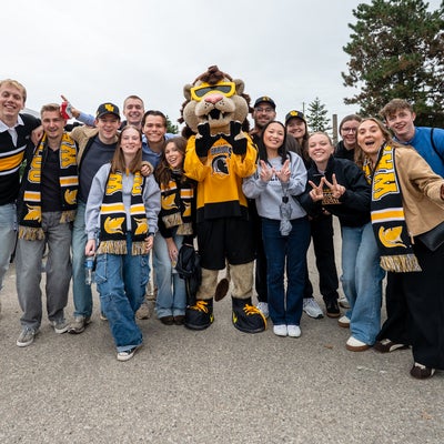 group of students with waterloo mascot, king warrior