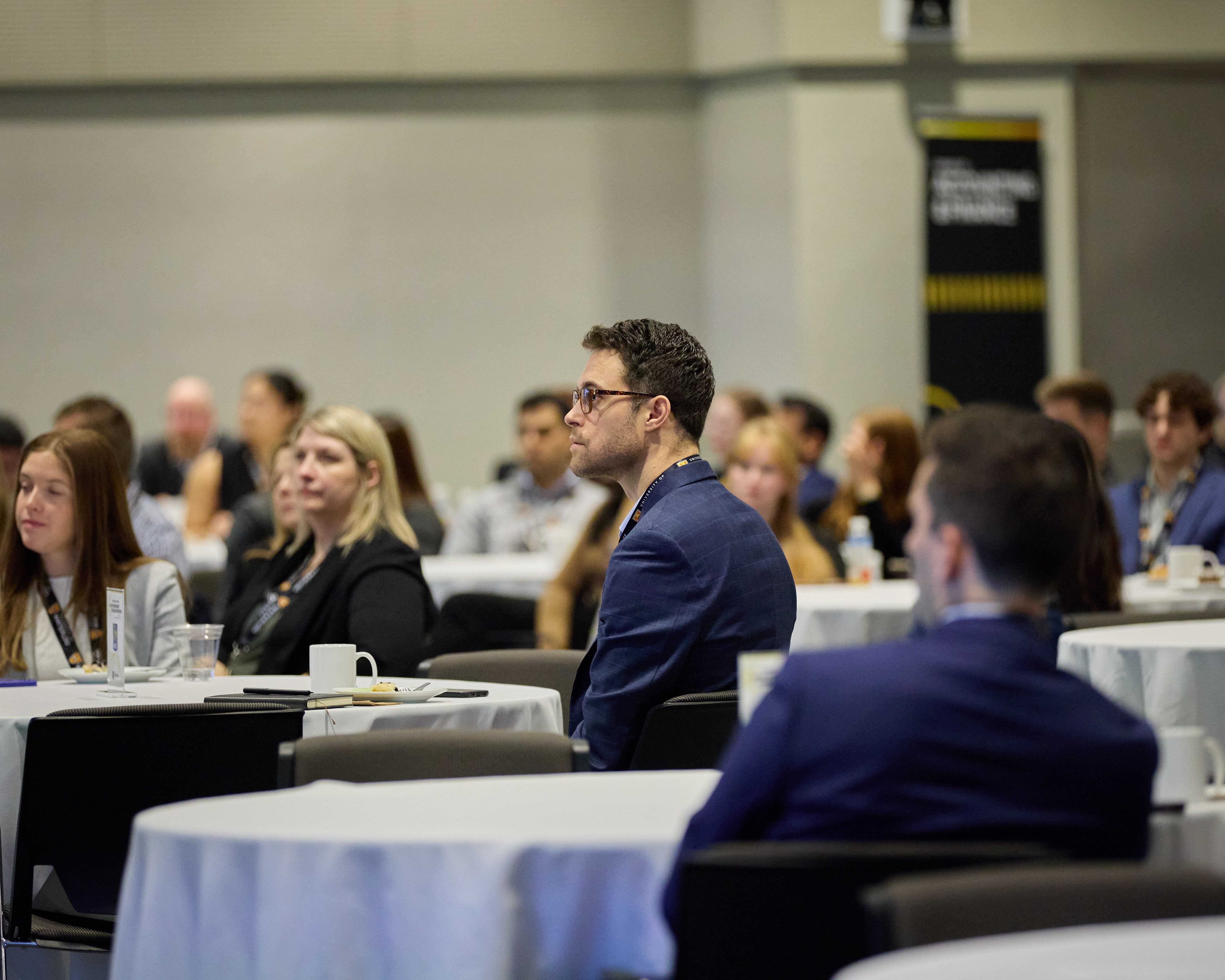 Conference guests at their tables.