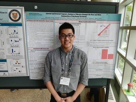 Leicester in front of his poster presentation