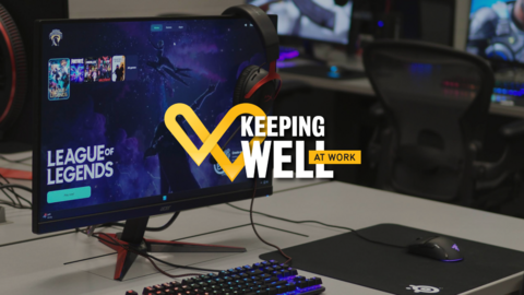 The Keeping Well at Work logo in front a desk gaming set-up for League of Legends
