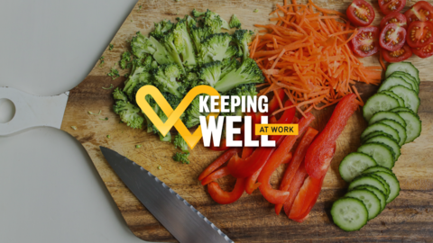 Chopped vegetables on a cutting board with a knife