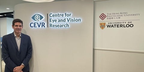 Professor Ben Thompson stands beside the sign to inaugurate the new Centre for Eye and Vision Research