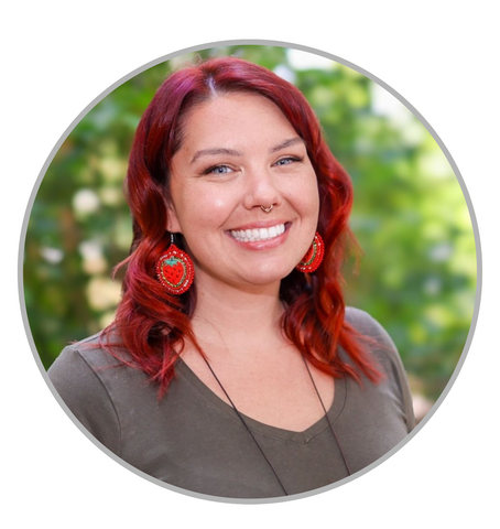 A woman with a friendly smile outdoors