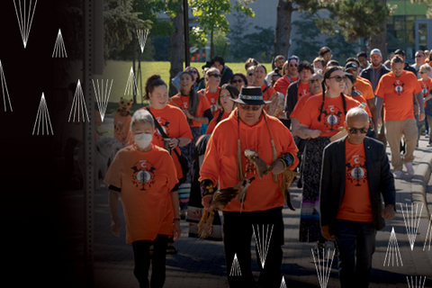 a group of people wearing orange shirts walk together